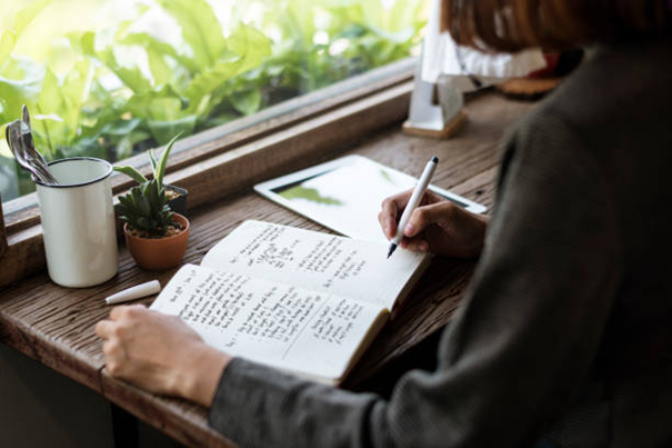 women writing a journal