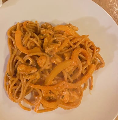 Chicken pasta with bell peppers and tomato sauce.