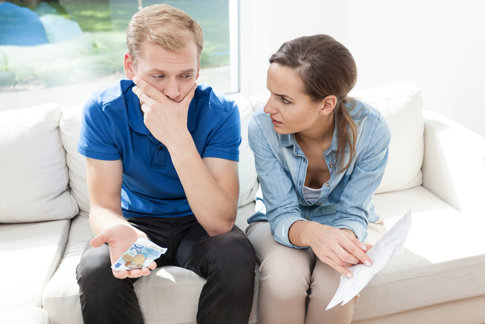 Young couple having problems with paying high bills