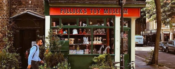 Pollock's Toy Museum store-front at 1 Scala Street with a man walking past and a bike parked out front