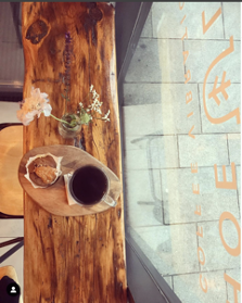 coffee_and_pastry_on_wooden_bench_with_window