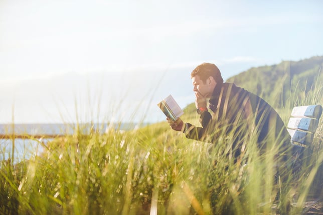 man reading mental health book